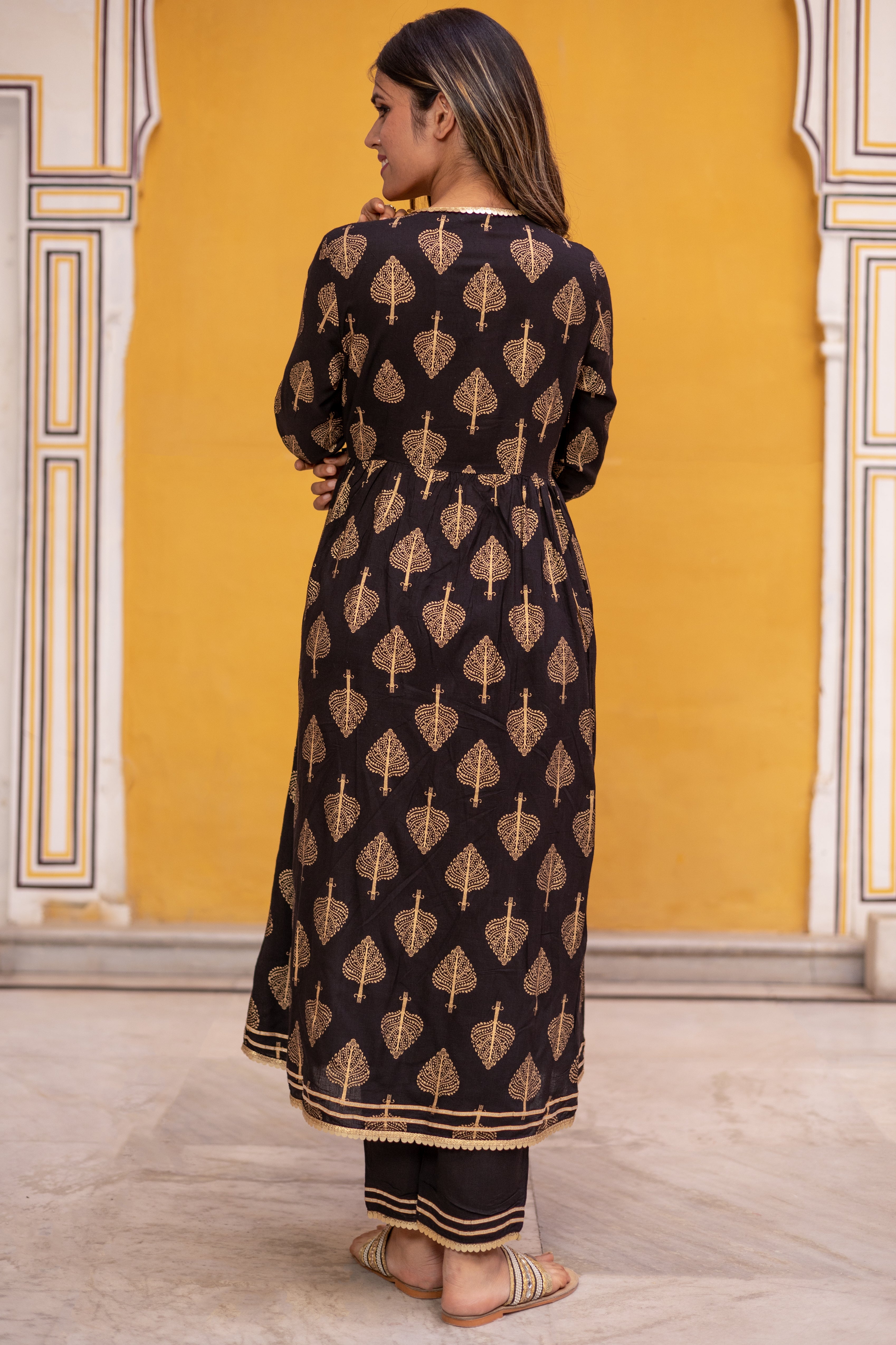 Black Gold Printed Angarkha Style Flared Kurti with Gathers and Narrow Pant.